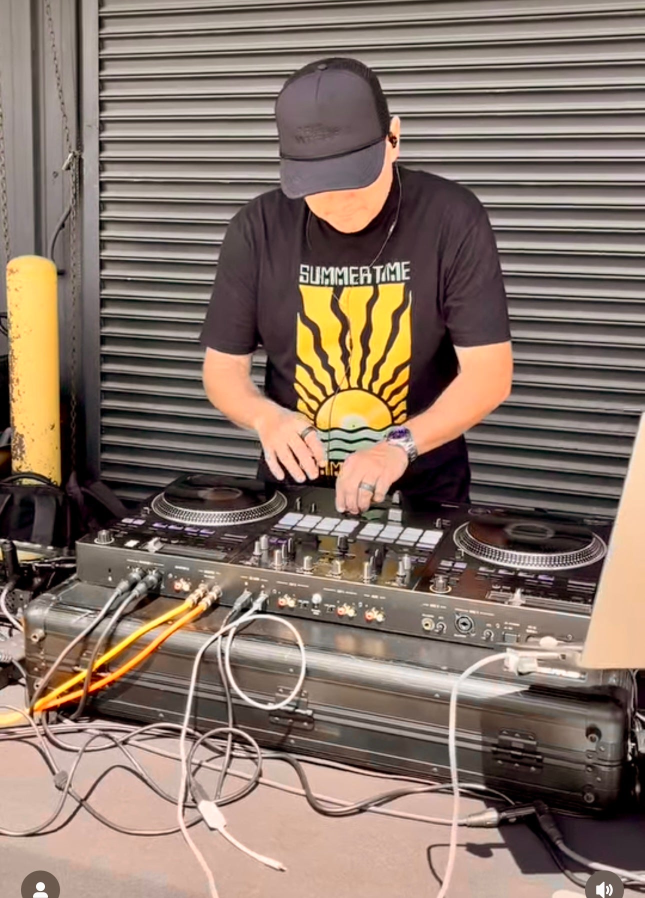 Person operating DJ equipment in front of a turntable